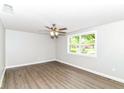 Bright bedroom with neutral walls, wood-look flooring, and large picture window at 12029 Meadow Ln, Indianapolis, IN 46236