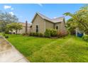 This inviting residence features a spacious lawn, enhanced by lush greenery and vibrant floral accents at 1211 W 10Th St, Muncie, IN 47302