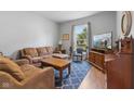 Cozy living room featuring hardwood floors, a patterned rug and blue accent chair at 1211 W 10Th St, Muncie, IN 47302