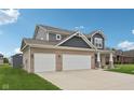 Beautiful two-story home with a three-car garage and well-maintained lawn at 13163 N Departure W Blvd, Camby, IN 46113