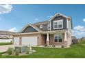 Attractive two-story home with a three-car garage and lush green lawn at 13163 N Departure W Blvd, Camby, IN 46113