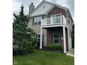 View of the home's exterior highlighting the brick facade, second story balcony, and attached garage at 13225 Deception Pass # 1200, Fishers, IN 46038