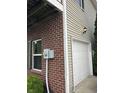 Attached one-car garage featuring brick and siding exterior and side yard at 13225 Deception Pass # 1200, Fishers, IN 46038