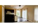 Bright eat-in kitchen featuring dark cabinetry, stainless steel appliances, and a stylish pendant light at 13225 Deception Pass # 1200, Fishers, IN 46038