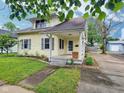 Charming home featuring a well-maintained lawn, inviting porch, and beautiful landscaping at 1336 Lafayette Ave, Columbus, IN 47201