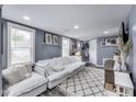 Bright living room with modern decor, plush seating, and ample natural light at 1617 S Whittier Pl, Indianapolis, IN 46203