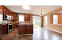 Modern kitchen with wood cabinets, stainless steel appliances, and a breakfast bar island at 16247 Countryside Blvd, Westfield, IN 46074