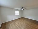 Spacious bedroom with hardwood floors, ceiling fan and natural light from the window at 1653 Wade St, Indianapolis, IN 46203