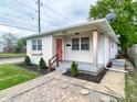 Charming single-story home with brick facade, landscaped front yard, and inviting entryway at 1653 Wade St, Indianapolis, IN 46203