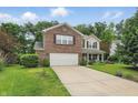 Inviting two-story home with brick and siding, featuring an attached two-car garage and green front yard at 16732 Maraschino Dr, Noblesville, IN 46062