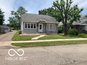 Well-maintained home with gray siding, a green lawn, and a walkway leading to the front entrance at 1728 Newton St, Columbus, IN 47201
