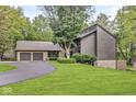 Beautiful home with a two-car garage and a large front yard with mature trees at 20322 Wagon Trail Dr, Noblesville, IN 46060