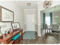 Welcoming entryway featuring elegant decor, a wood console table, and a view into the dining area at 2260 Santa Fe Dr, Greenfield, IN 46140