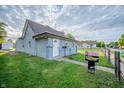 Well-maintained light blue home featuring a manicured lawn and neat landscaping at 2358 Hovey St, Indianapolis, IN 46218