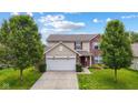 Charming two-story home featuring brick and siding, a two-car garage, and a well-maintained front yard at 2509 Cedarmill Dr, Franklin, IN 46131