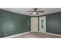 Green bedroom featuring neutral carpeting, overhead fan and fixture, and natural lighting at 2823 Boulevard Pl, Indianapolis, IN 46208