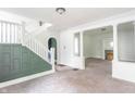 Inviting living room with staircase, fresh white trim, and a classic fireplace at 2823 Boulevard Pl, Indianapolis, IN 46208