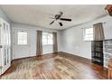 Bright living room featuring hardwood floors, large windows, and a ceiling fan at 2840 Denison St, Indianapolis, IN 46241