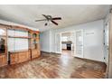 Spacious living room with hardwood floors, ceiling fan, and opening to kitchen at 2840 Denison St, Indianapolis, IN 46241