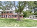 Traditional brick home featuring a lush lawn and two-car detached garage at 3030 E 236Th St, Cicero, IN 46034