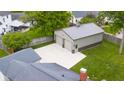 Aerial view showcasing a detached two-car garage with a large concrete pad and a well-kept lawn on a sunny day at 3113 Westenedge Dr, Columbus, IN 47203