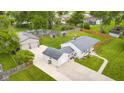 Aerial view of property featuring a well-maintained lawn, pool, detached garage, privacy fence, and a shed in the backyard at 3113 Westenedge Dr, Columbus, IN 47203