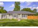 Inviting single-story home with a well-kept lawn, walkway leading to the front door, and black window shutters at 3113 Westenedge Dr, Columbus, IN 47203