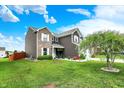 Beautifully landscaped yard featuring mature trees, lush greenery, and a charming two-story home exterior at 3284 Clary Blvd South Dr, Greenwood, IN 46143