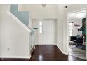 Bright foyer with hardwood floors, staircase with blue accent, and an open view to a salon-style room at 3284 Clary Blvd South Dr, Greenwood, IN 46143