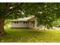Charming single-story home with mature tree offering ample shade in a well-maintained yard at 3431 W Mooresville Rd, Indianapolis, IN 46221