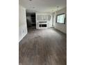 Living room featuring hardwood floors, fireplace with plaster walls, and natural light from the windows at 3526 Evergreen Ave, Indianapolis, IN 46205