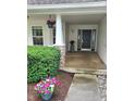 Inviting front porch with decorative plants and a view of the well maintained yard at 3862 Cornwallis Ln, Carmel, IN 46032