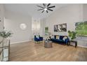 Spacious living room with hardwood floors, blue sofa set and neutral wall color at 3926 Rosefinch Cir, Indianapolis, IN 46228