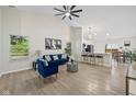 Open-concept living room with modern furniture, hardwood floors, and a high vaulted ceiling at 3926 Rosefinch Cir, Indianapolis, IN 46228