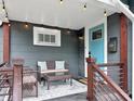 Inviting covered front porch with comfortable seating and stylish decor; perfect for relaxing outdoors at 4345 Guilford Ave, Indianapolis, IN 46205