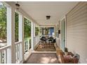 Relaxing front porch featuring a table, chairs, and cozy outdoor seating area at 4818 Winthrop Ave, Indianapolis, IN 46205