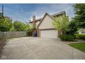 Attached two-car garage with concrete driveway and a basketball hoop at 4949 Jennings Dr, Carmel, IN 46033