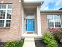 Inviting front entrance with a brightly painted blue door, sidelights and decorative features at 5010 Cabrillo Dr, Plainfield, IN 46168