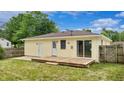 Private backyard featuring a wooden deck and a door leading to the outside at 5806 E 19Th St, Indianapolis, IN 46218