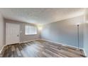 Bright living room with large window and modern flooring, creating an open and airy space at 5806 E 19Th St, Indianapolis, IN 46218