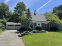 Cozy home with a two-car garage and mature trees surrounding the landscaped front yard at 5889 Crestview Ave, Indianapolis, IN 46220