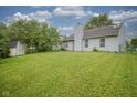 Expansive backyard features a storage shed and lush green lawn perfect for outdoor activities at 7724 Blackthorn Dr, Indianapolis, IN 46236