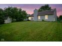 Expansive backyard features a storage shed and lush green lawn perfect for outdoor activities at 7724 Blackthorn Dr, Indianapolis, IN 46236
