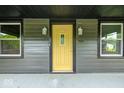 Inviting front entrance with a yellow door, exterior lights, and the house number 805 at 805 N Euclid Ave, Indianapolis, IN 46201