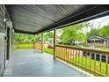 Open-air front porch offering a glimpse of the neighborhood street and surrounding homes at 805 N Euclid Ave, Indianapolis, IN 46201