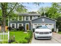 Inviting home featuring a manicured lawn and a driveway with a white Durango parked at 8272 Calgary Ct, Indianapolis, IN 46268