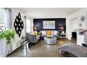 Elegant living room showcasing a dark accent wall, modern decor, and stylish gray furniture at 8272 Calgary Ct, Indianapolis, IN 46268