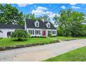 Charming white home with black shutters, a red door, and a well-kept lawn at 8301 E County Road 801 S, Plainfield, IN 46168