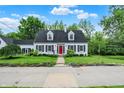 Beautiful white home with black shutters and a vibrant red front door at 8301 E County Road 801 S, Plainfield, IN 46168