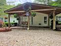 Inviting covered porch with hanging swing, decorative wreaths, and outdoor seating at 8310 Dog Trot Ln, Morgantown, IN 46160